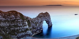 Beach with cliff arch overlooking the sea